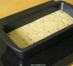 Banana bread mixture in tin ready for cooking
