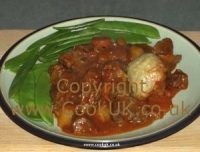 Beef casserole served with vegetables and dumplings