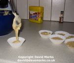 Pouring cake mixture into cake cases