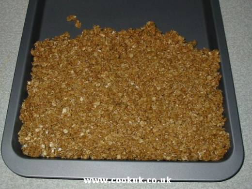Spoon flapjack mixture onto baking tray