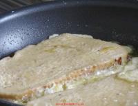 Eggy bread frying in a pan