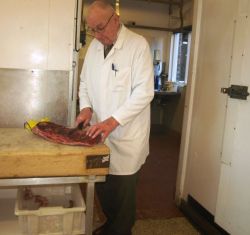 Butcher carving beef