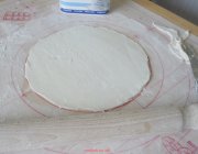 A round of uncooked puff pastry