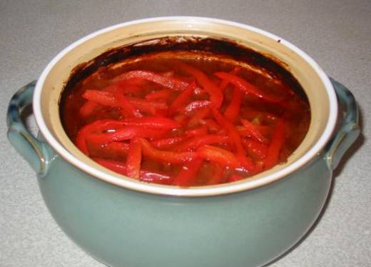 Goulash topped with red peppers