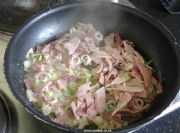 Ham and spring onions frying in butter