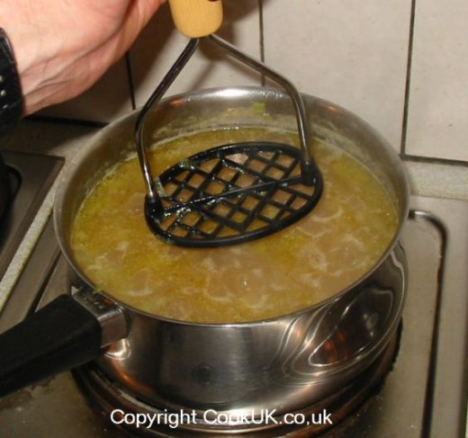 Mashing potatoes in the pan