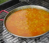 Fish stock added to seafood paella