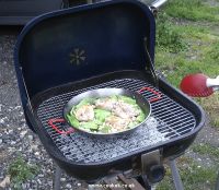 Chicken and beans frying on barbecue