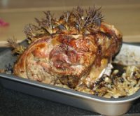 Roast lamb studded with rosemary and garlic
