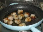 Sliced sausages frying