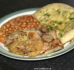 Sausage and potato bake with garlic bread and beans