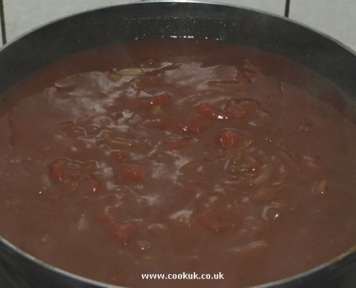 Add stock and tomatoes