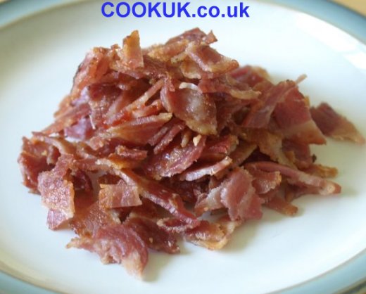 Cut up cooked streaky bacon