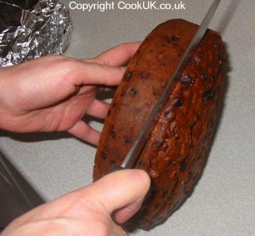 Cutting top of XMAS cake for marzipan