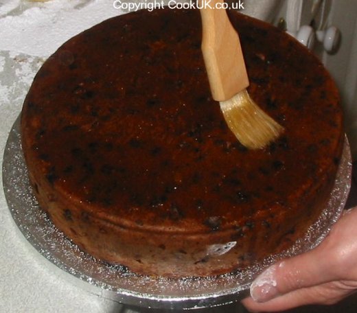 Coat surface of Christmas cake with jam