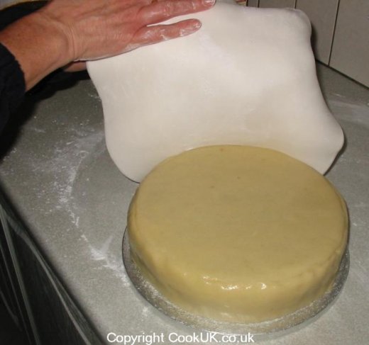 Transfer ready roll icing to cake