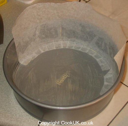 Cake tin partially lined with greaseproof  paper