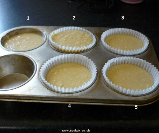 Containers filled with cup cake mixture