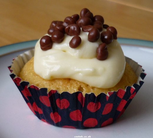 Cupcake covered in cream cheese and chocolate