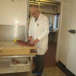 Kineton butcher boning and rolling sirloin joint