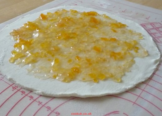 Spread apricot jam over pastry