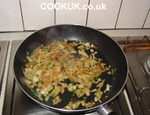 Frying onions, chilies and garlic