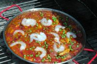 Add prawns and peas to the paella