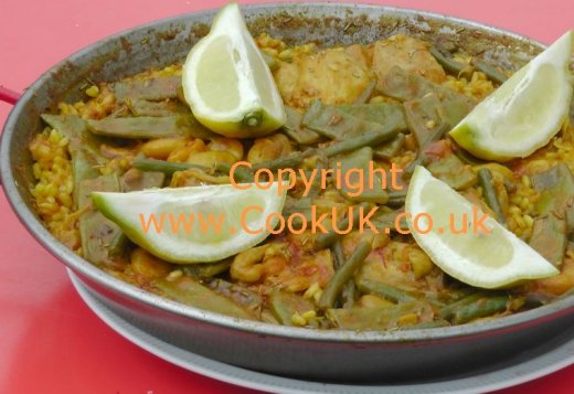 Paella Valenciana cooked in a paella pan