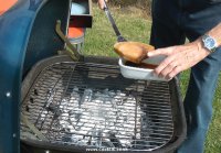 Placing swordfish on barbecue
