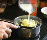Adding milk to mashed potato